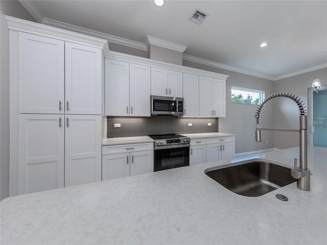 kitchen featuring stainless steel appliances and white cabinets