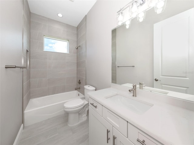 full bathroom featuring toilet, tiled shower / bath combo, hardwood / wood-style flooring, and vanity