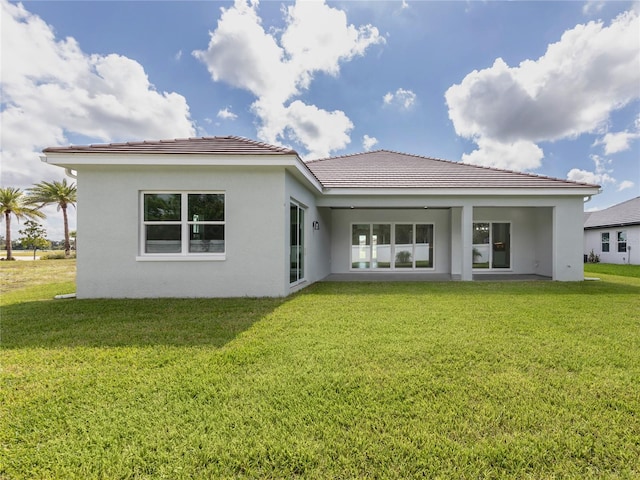 back of house featuring a yard