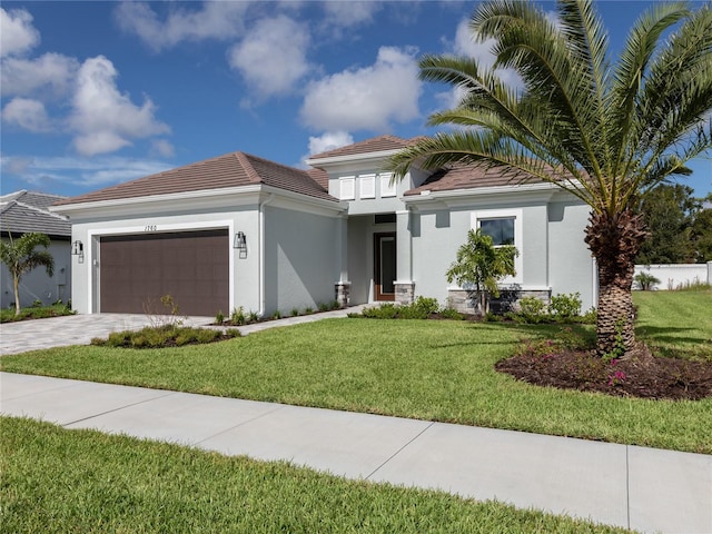 view of front facade featuring a front yard and a garage