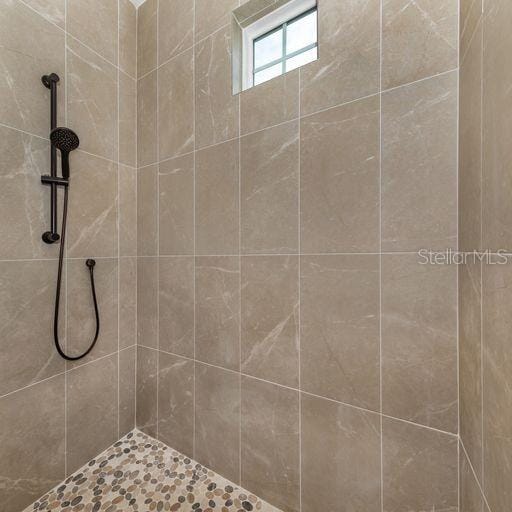 bathroom with a tile shower