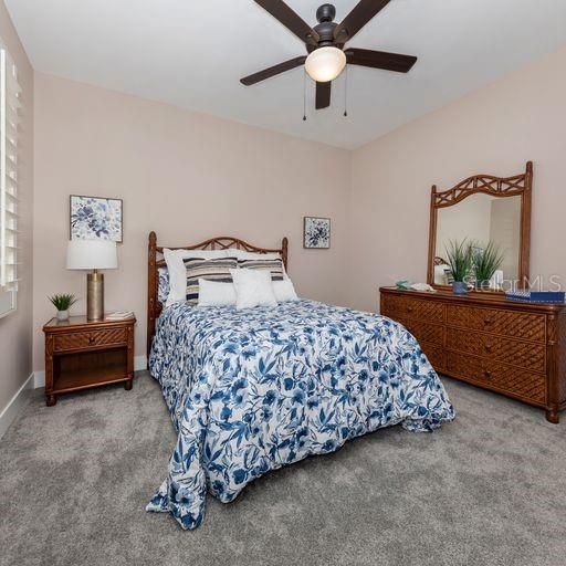 carpeted bedroom with ceiling fan