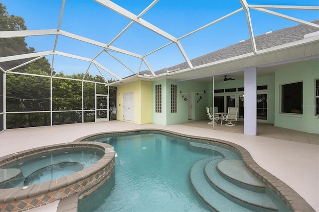 view of swimming pool featuring a lanai, a patio area, ceiling fan, and an in ground hot tub