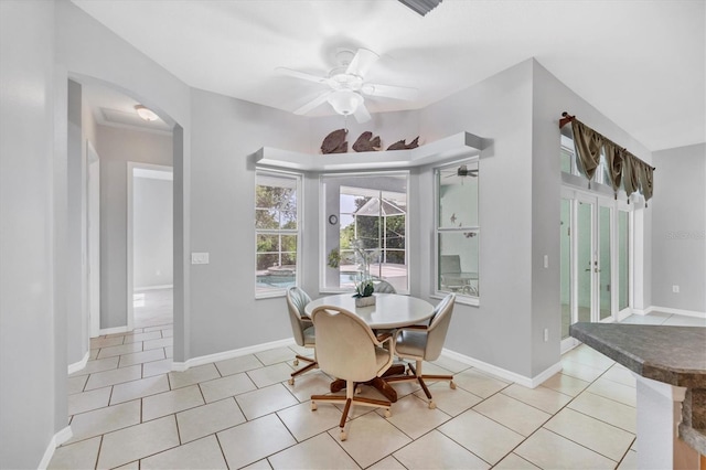 tiled dining space with ceiling fan