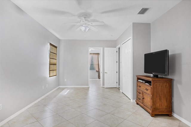 living room featuring ceiling fan and light tile patterned flooring