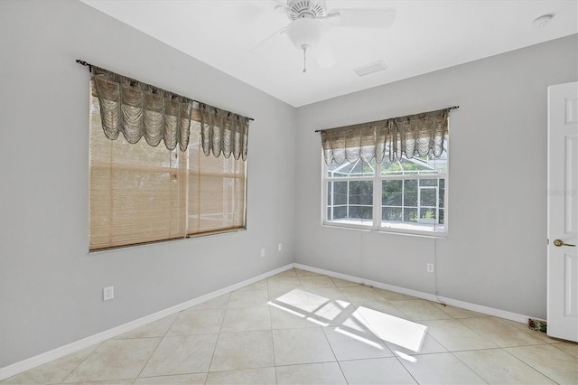 tiled empty room with ceiling fan