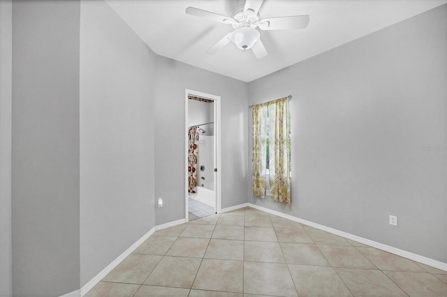 unfurnished room with ceiling fan and light tile patterned floors