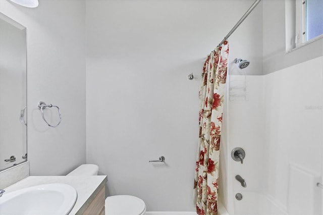 full bathroom featuring vanity, shower / bath combo, and toilet