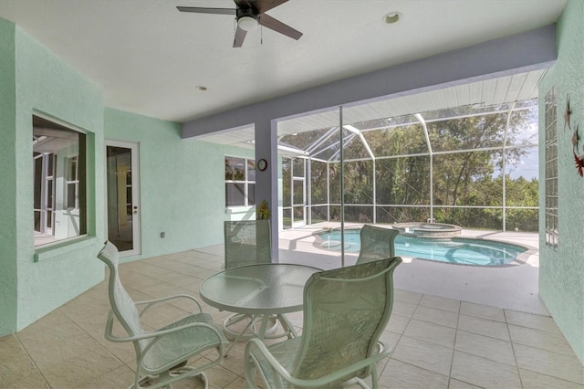 view of patio featuring glass enclosure, ceiling fan, and a pool with hot tub