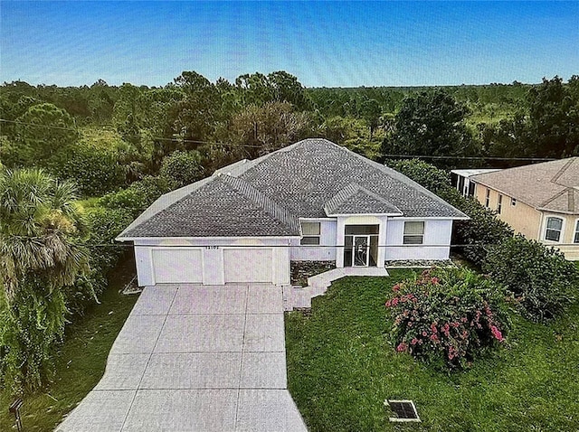 view of front of property with a garage and a front lawn