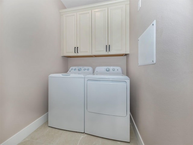 laundry room with separate washer and dryer, cabinets, and light tile patterned floors