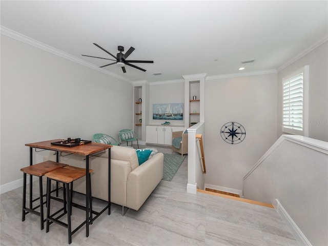 living room with ornamental molding and ceiling fan