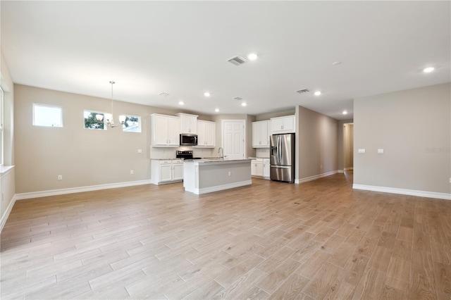 kitchen with open floor plan, appliances with stainless steel finishes, and a sink