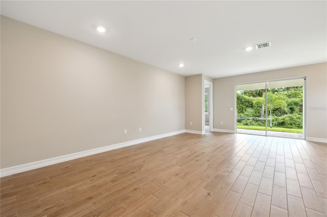 spare room with recessed lighting, baseboards, visible vents, and light wood finished floors