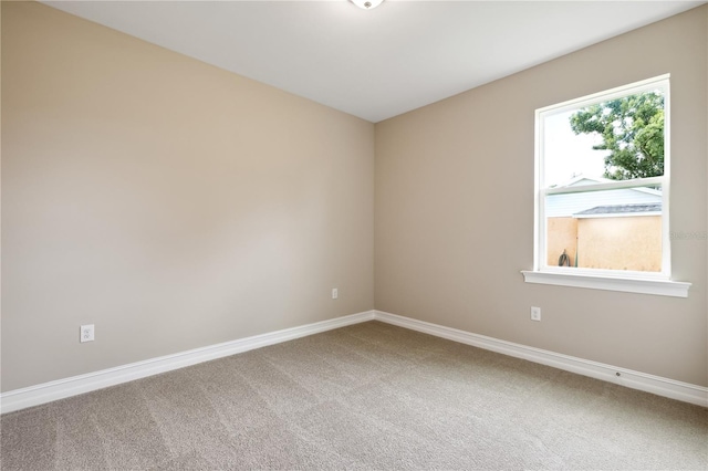 carpeted spare room with baseboards