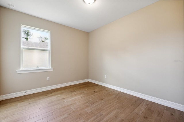 unfurnished room featuring light wood-style floors and baseboards