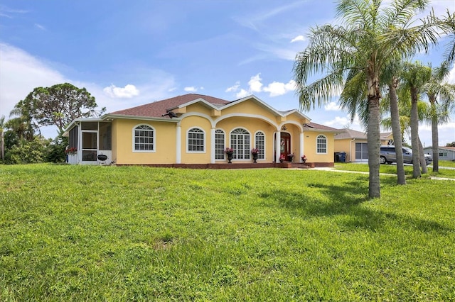 mediterranean / spanish house featuring a front lawn