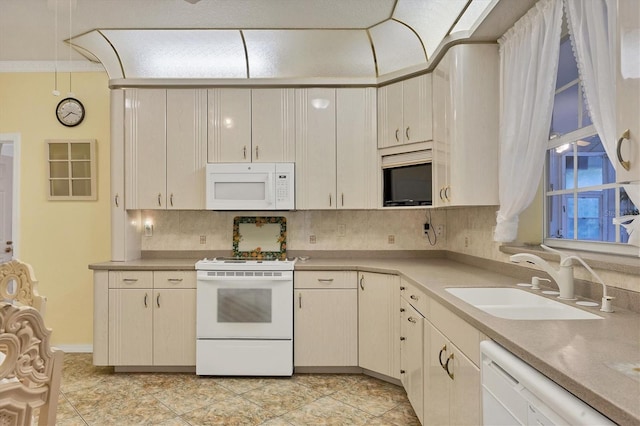 kitchen featuring decorative backsplash, sink, and white appliances