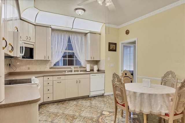 kitchen featuring tasteful backsplash, dishwasher, sink, and range