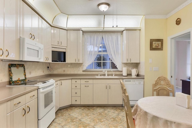 kitchen with crown molding, sink, tasteful backsplash, and white appliances