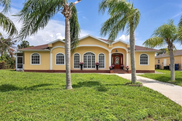 mediterranean / spanish-style house featuring a front lawn