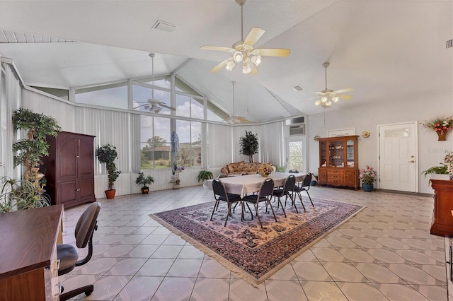 dining area with ceiling fan, light tile patterned floors, and high vaulted ceiling