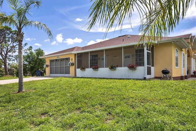 ranch-style home featuring a garage and a front yard