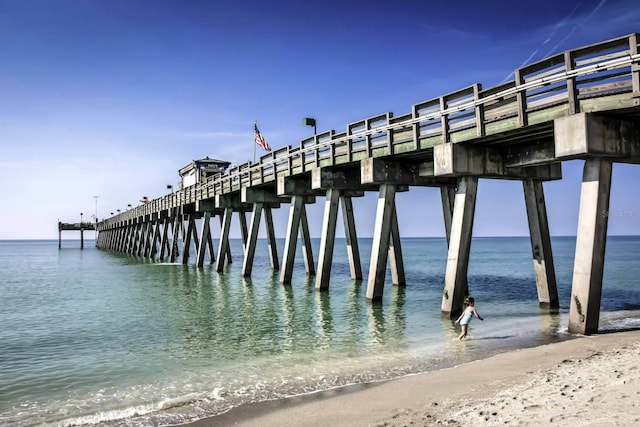 dock area with a view of the beach and a water view