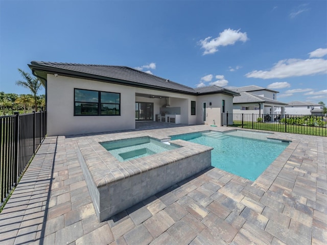 view of swimming pool featuring a patio area and an in ground hot tub