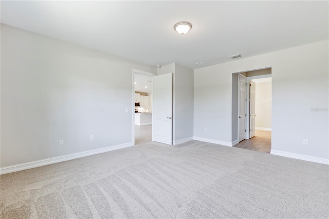 empty room featuring light carpet