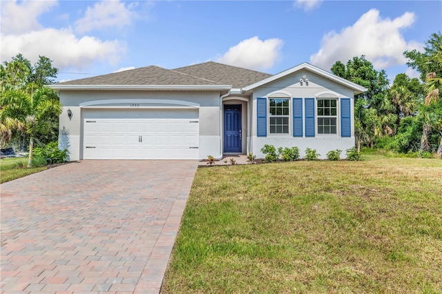 ranch-style house featuring a front lawn and a garage