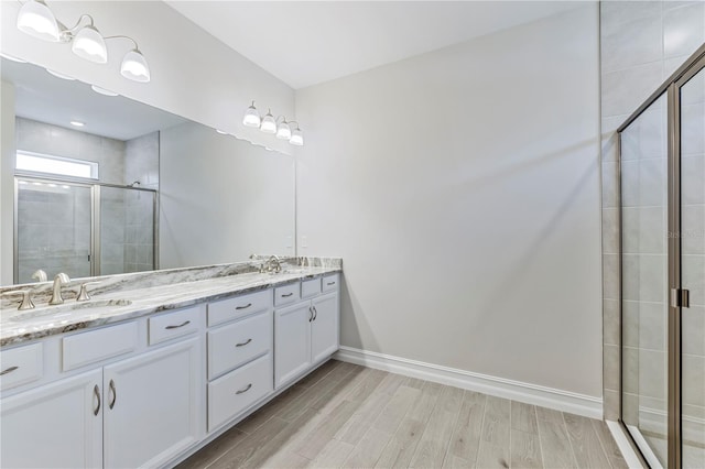 bathroom featuring a shower with door, vanity, and hardwood / wood-style floors