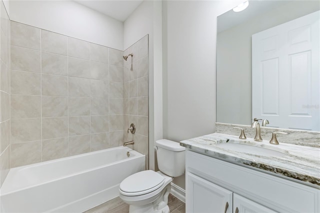 full bathroom featuring vanity, toilet, and tiled shower / bath