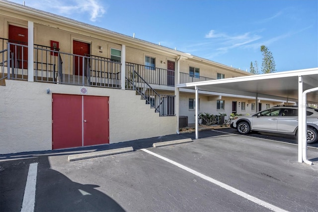 view of property featuring a carport and central air condition unit