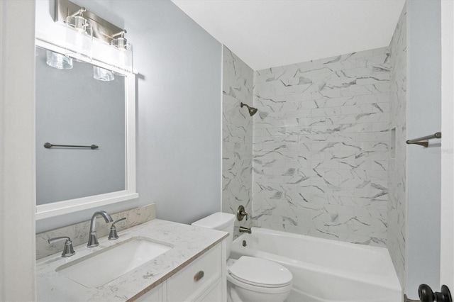 full bathroom featuring vanity, toilet, and tiled shower / bath