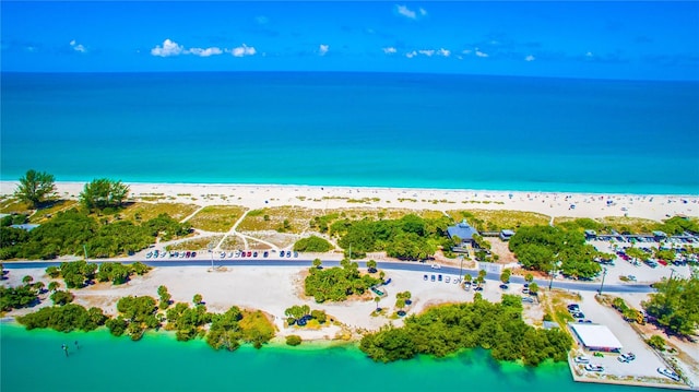 drone / aerial view with a beach view and a water view