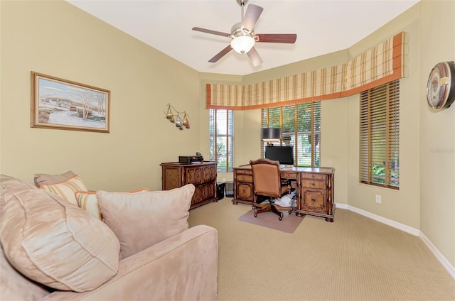 office area with ceiling fan and light carpet