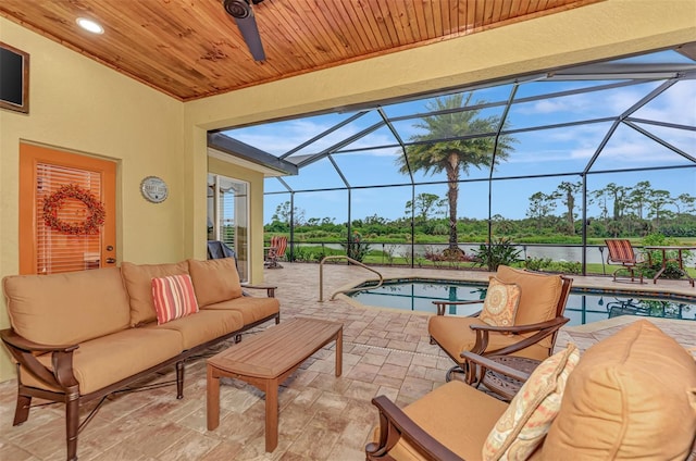 view of swimming pool with outdoor lounge area, a patio area, and a lanai