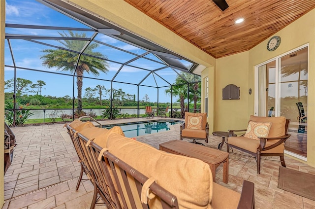 view of patio featuring outdoor lounge area, a water view, and glass enclosure