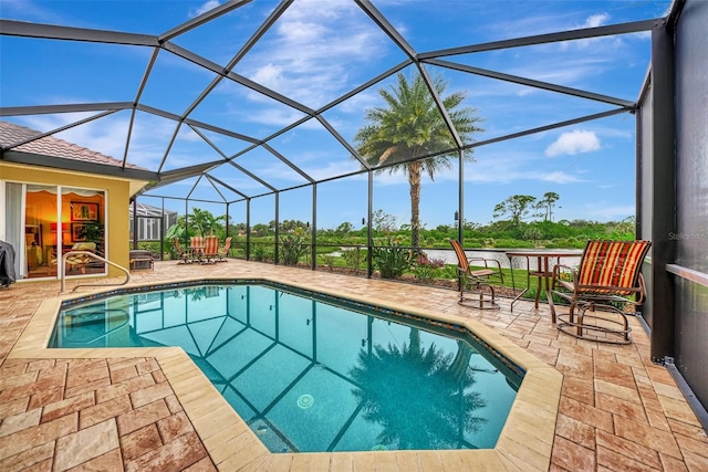 view of pool with a patio area and a lanai