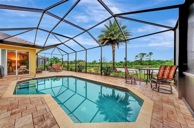 view of pool with a patio and a lanai