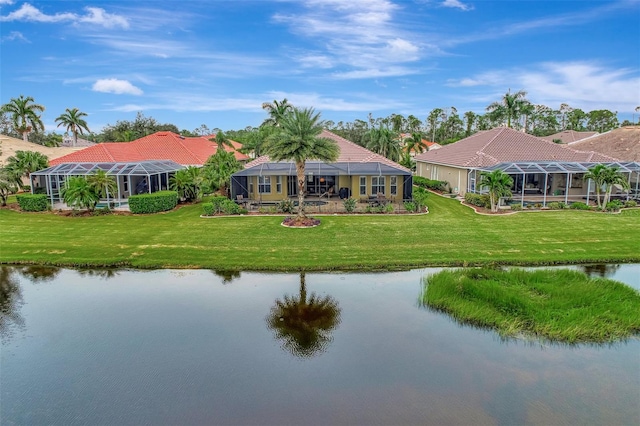 exterior space with a water view, a lanai, and a lawn