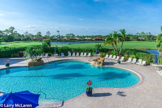 view of pool featuring a patio area and a water view