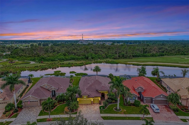 aerial view at dusk with a water view