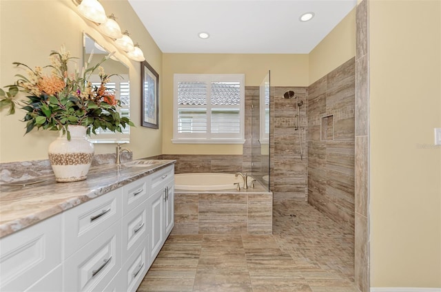 bathroom with vanity and independent shower and bath