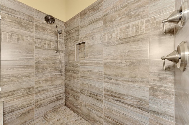 bathroom with a tile shower