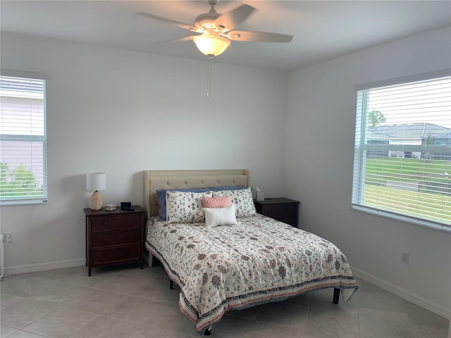 tiled bedroom featuring ceiling fan