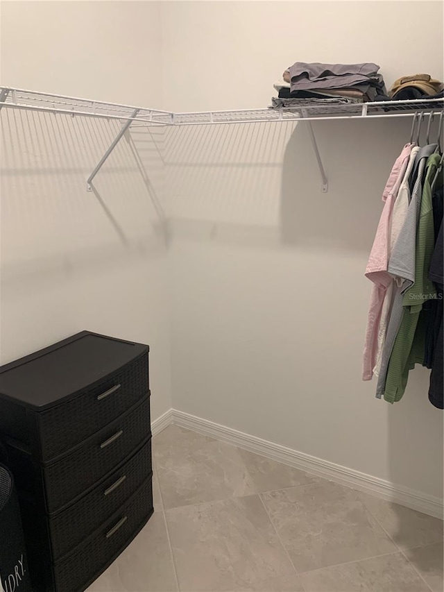 spacious closet featuring light tile floors