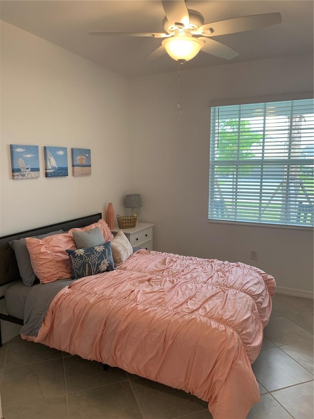 bedroom with ceiling fan and light tile flooring