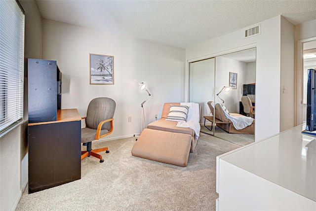 carpeted home office with a textured ceiling